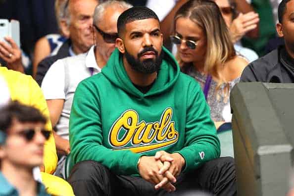 Drake courtside of a basketball game