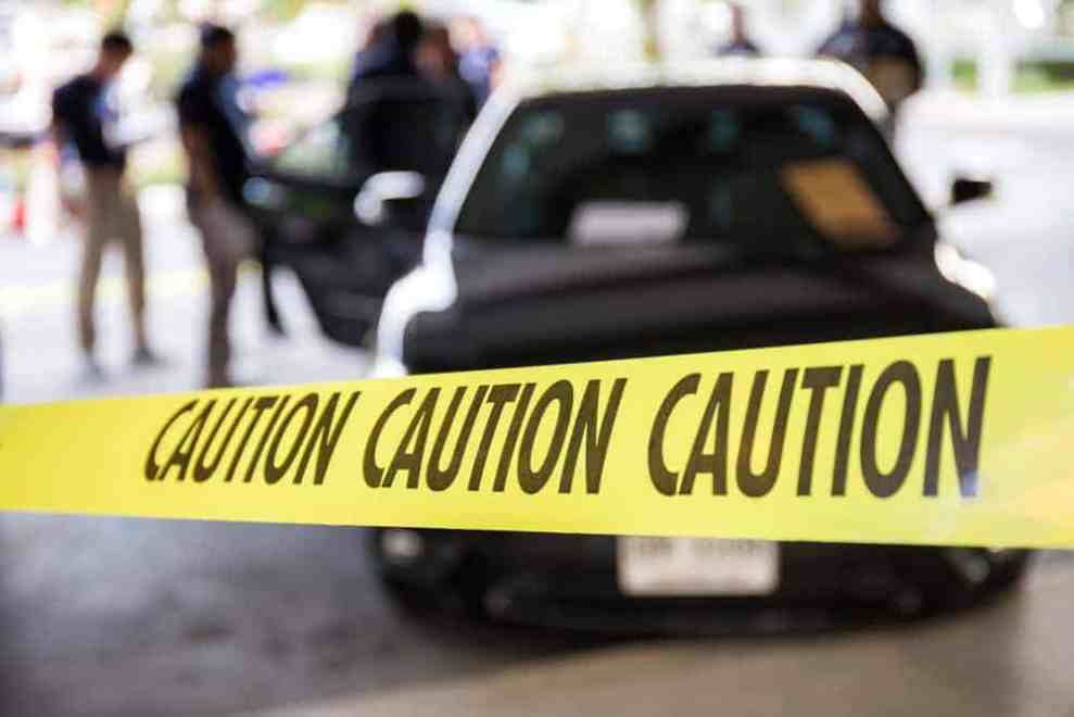 caution tape and a police car at a crime scene