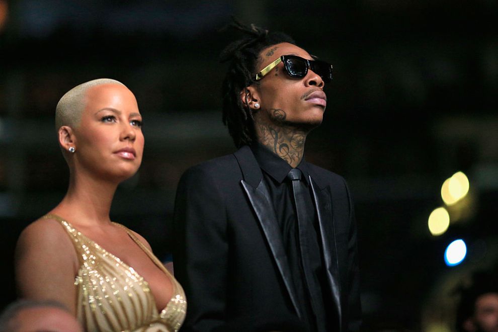 Recording artist Wiz Khalifa featured wearing Converse in support of the GRAMMY Foundation's GRAMMY Camp and model Amber Rose attends the 56th GRAMMY Awards at Staples Center on January 26, 2014 in Los Angeles, California.
