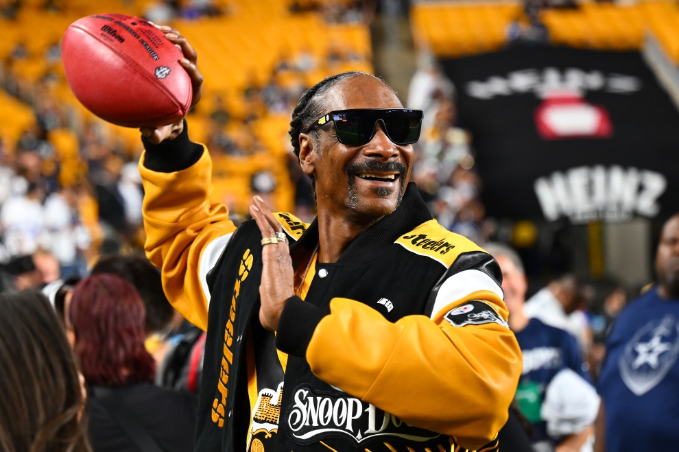 PITTSBURGH, PENNSYLVANIA - OCTOBER 06: Snoop Dogg throws the ball prior to the game between the Dallas Cowboys and the Pittsburgh Steelers at Acrisure Stadium on October 06, 2024 in Pittsburgh, Pennsylvania.
