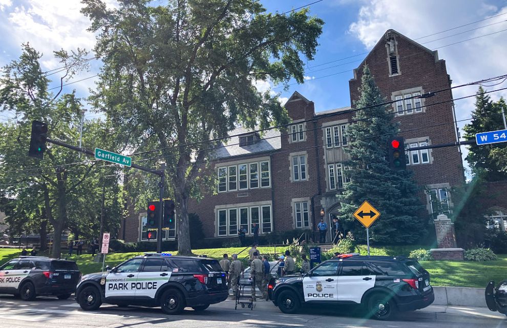 Police and first responders work at the scene of a shooting near Annunciation Church and Catholic School in Minneapolis, Minneosta, on August 27, 2025. Two children were shot dead when a gunman attacked a Minneapolis church on Wednesday, with 17 people injured, 14 of them children, police said. The gunman "began firing a rifle through the church windows towards the children sitting in the pews at the mass," Minneapolis police chief Brian O'Hara told reporters. The pupils were marking the first week of the school year when the attack occurred.